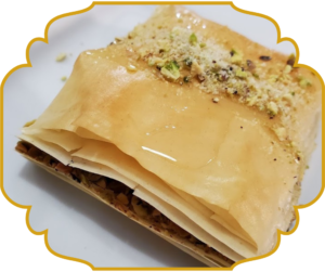Baklava with flaky phyllo pastry layers, honey syrup, and crushed pistachios at That Lebanese Place Springfield