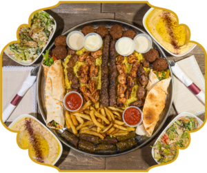 Family sharing tray at That Lebanese Place, a large platter of mixed grills, falafel, warak enab, fries, dips, wraps, rice, salads, and sauces
