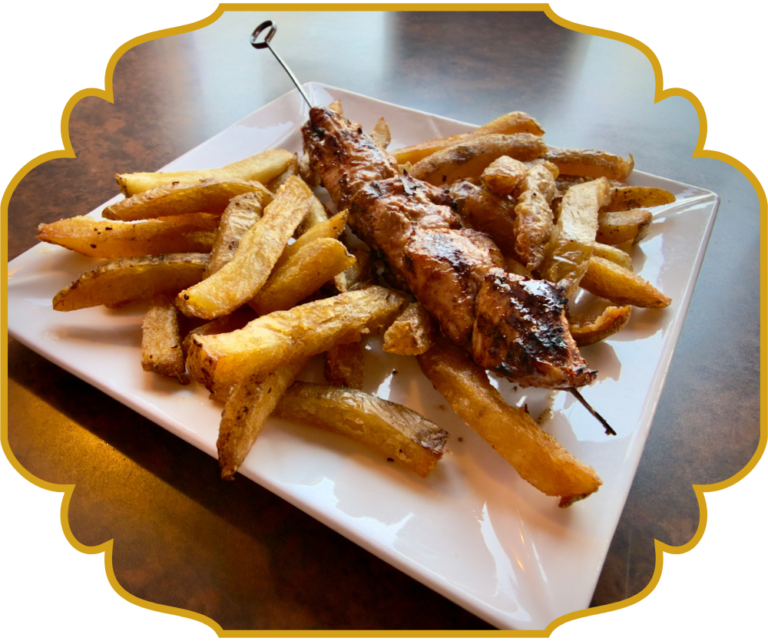Kids meal at That Lebanese Place, a grilled chicken skewer with Lebanese fries on a white plate, and drink.