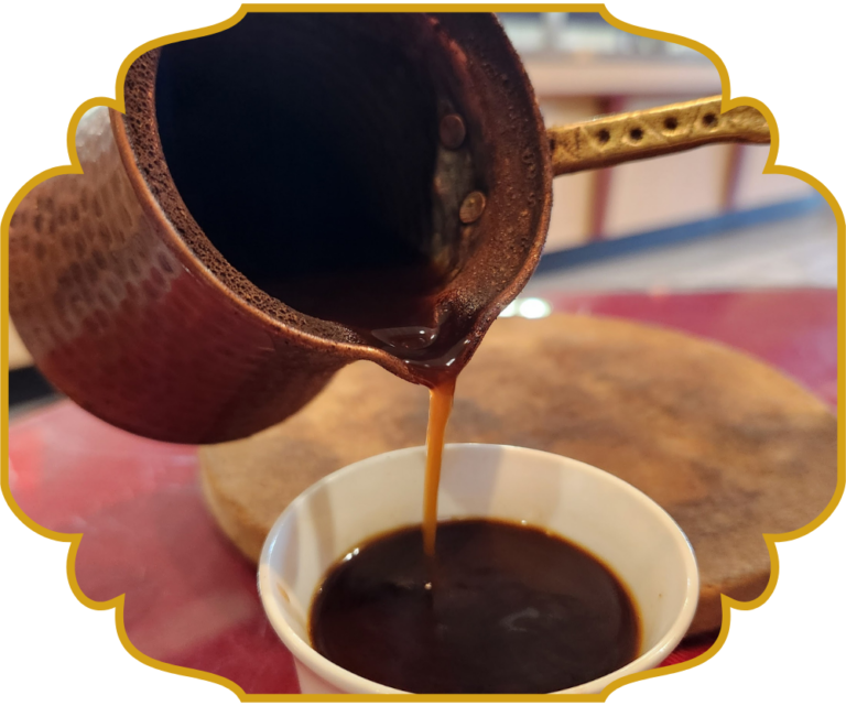 Lebanese coffee poured from a traditional copper dallah into a small cup at That Lebanese Place Springfield