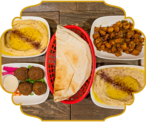 TLP sampler with hummus, baba ghanoush, falafel with tahini, batata harra, and fresh pita at That Lebanese Place
